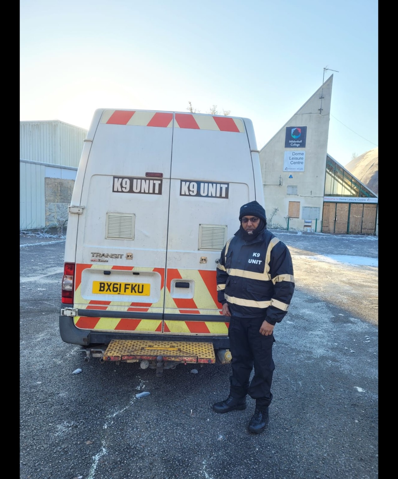 Secure9 K9 unit officer beside security vehicle